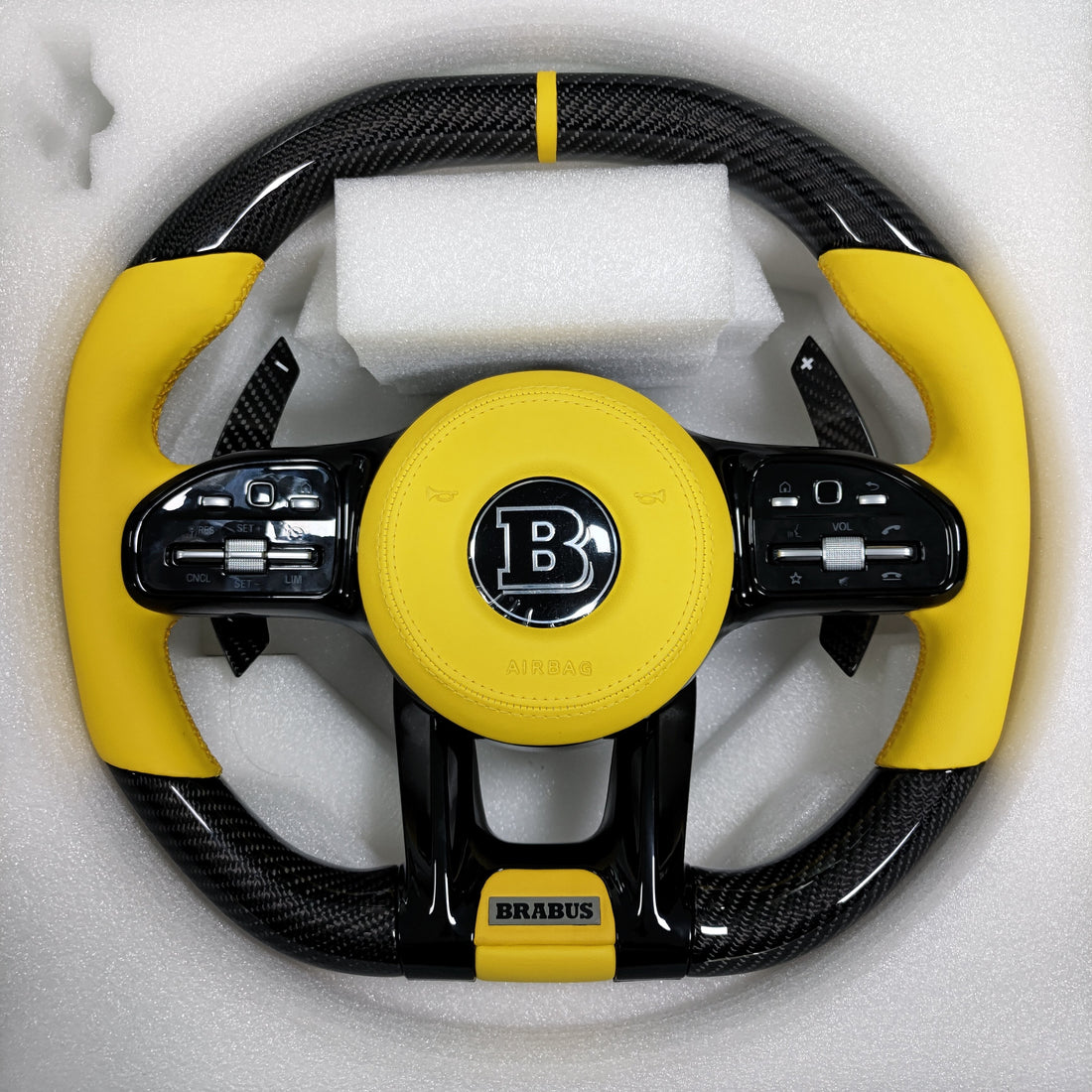 Carbon fiber steering wheel with yellow leather grips and center stripe