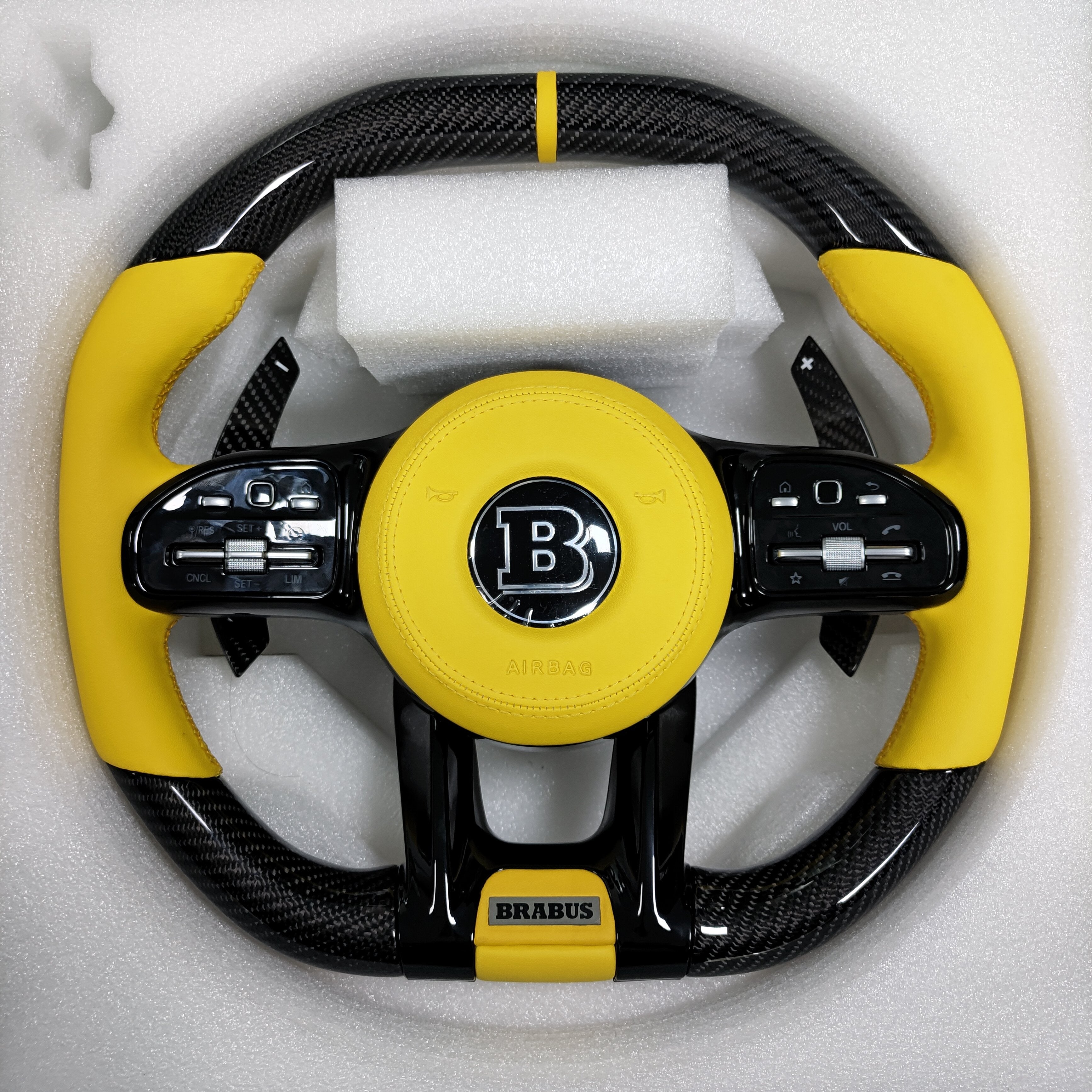 Carbon fiber steering wheel with yellow leather grips and center stripe