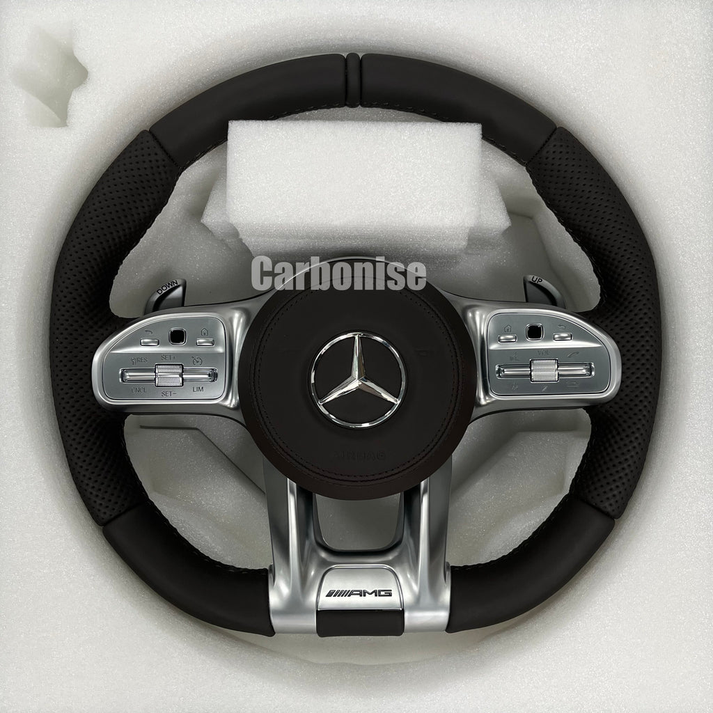 Custom Mercedes-Benz AMG steering wheel featuring a full black leather wrap with perforated side grips and integrated silver paddle shifters and controls.