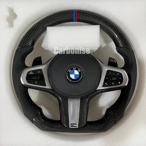 Custom BMW M steering wheel featuring high-gloss carbon fiber, a signature M-tri color top racing stripe, and black perforated leather side grips.