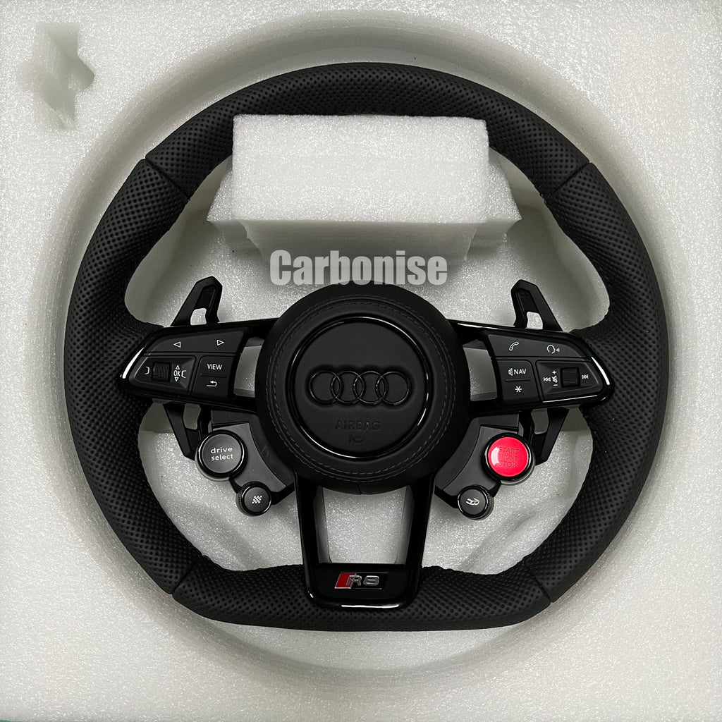 Custom Audi R8 performance steering wheel featuring full perforated leather grips, integrated red Start/Stop button, and Drive Select controls with a blacked-out center emblem.
