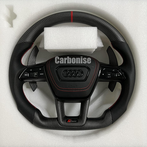 Custom Audi RS steering wheel with a matte carbon fiber finish, a red top racing stripe, and black perforated leather side grips with red contrast stitching.