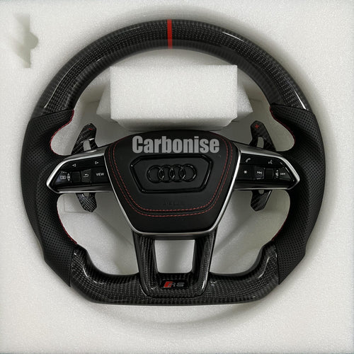 Custom Audi RS steering wheel with high-gloss carbon fiber, a red top racing stripe, and black perforated leather side grips with red stitching.