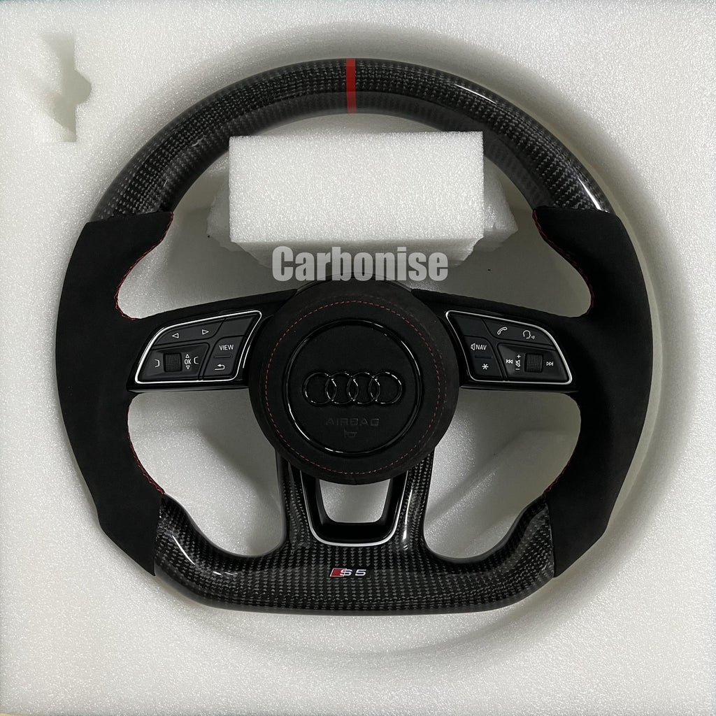 Custom Audi S6 steering wheel featuring gloss carbon fiber, a red top racing stripe, and black Alcantara side grips with red contrast stitching.