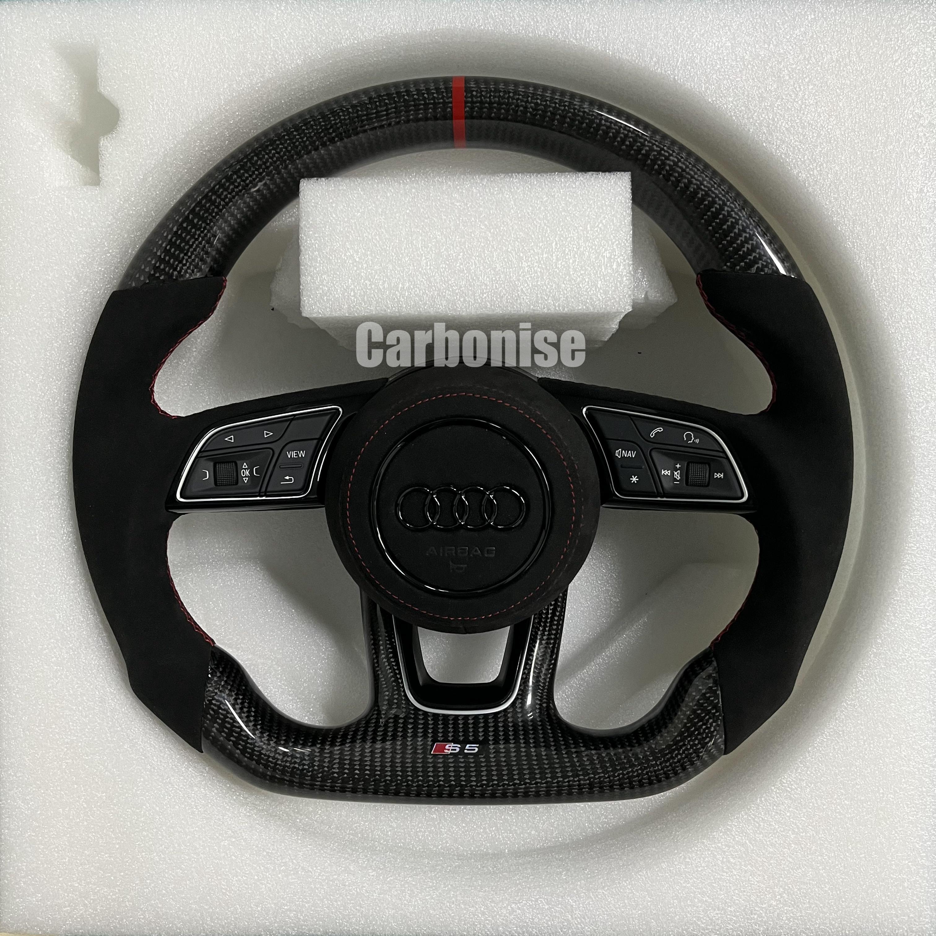 Custom Audi S6 steering wheel featuring gloss carbon fiber, a red top racing stripe, and black Alcantara side grips with red contrast stitching.