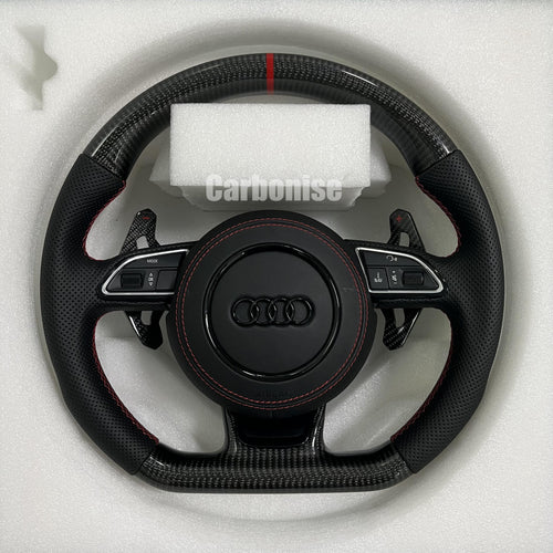 Audi carbon fiber flat-bottom steering wheel with red centre stripe, red stitching, perforated leather grips, paddle shifter and multifunction buttons.
