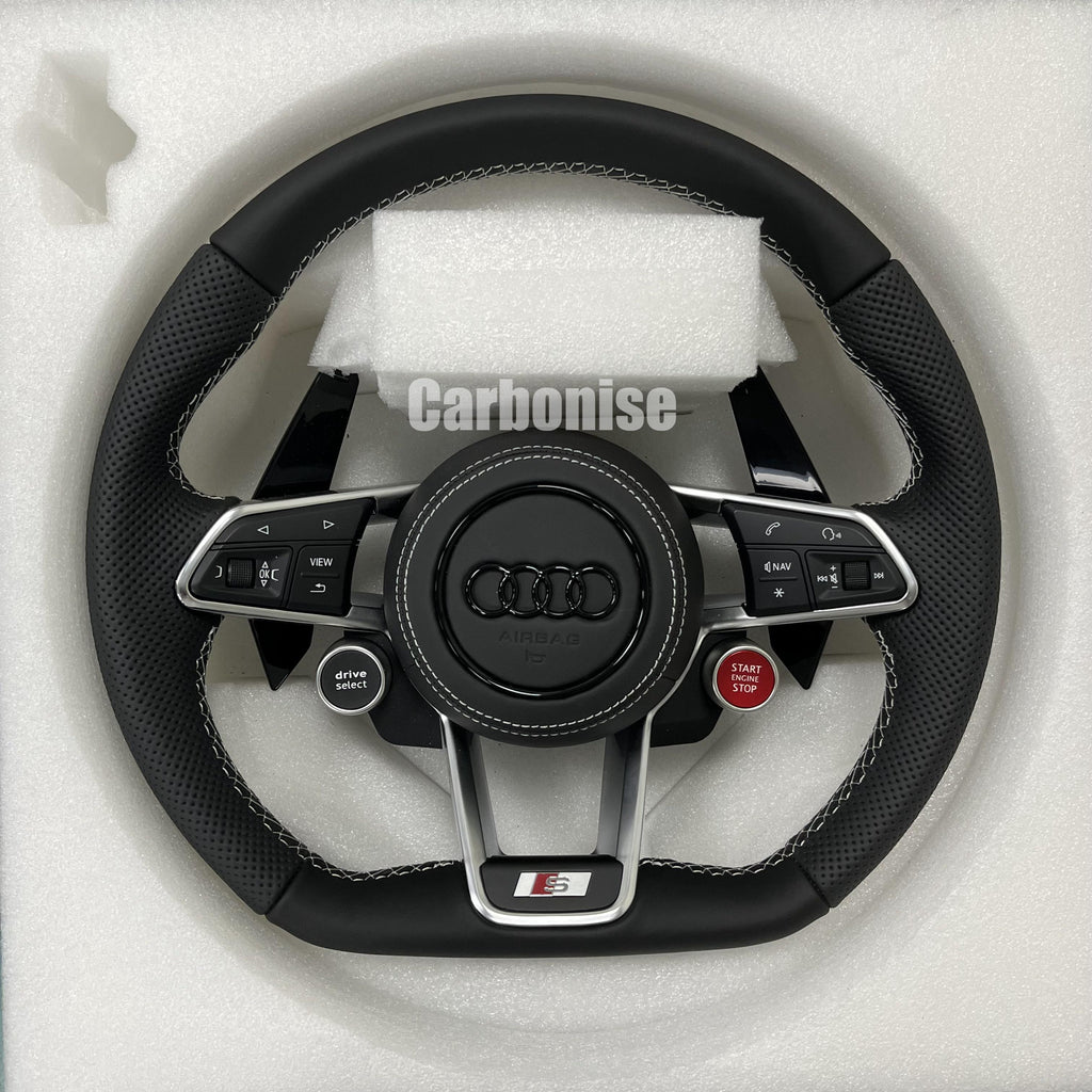 Custom Audi S performance steering wheel featuring black perforated leather grips, white contrast stitching, and integrated red Start/Stop and black Drive Select buttons.