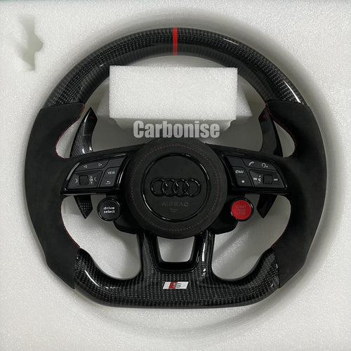Custom Audi S-Line steering wheel with gloss carbon fiber, a red top racing stripe, black Alcantara side grips with red stitching, and integrated R8-style performance buttons.