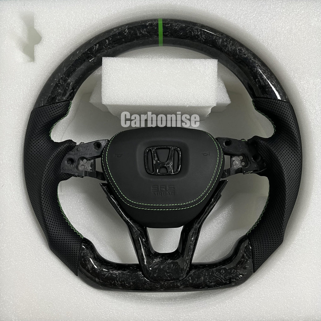 Custom Honda forged carbon steering wheel featuring a green center stripe, black perforated leather side grips, green stitching, and OEM Honda airbag mount.