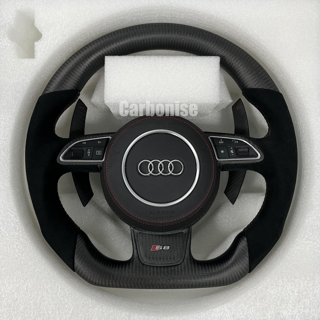 Custom Audi S8 steering wheel with a stealth matte carbon fiber finish, premium black Alcantara side grips, red stitching, and matching carbon fiber paddle shifters.