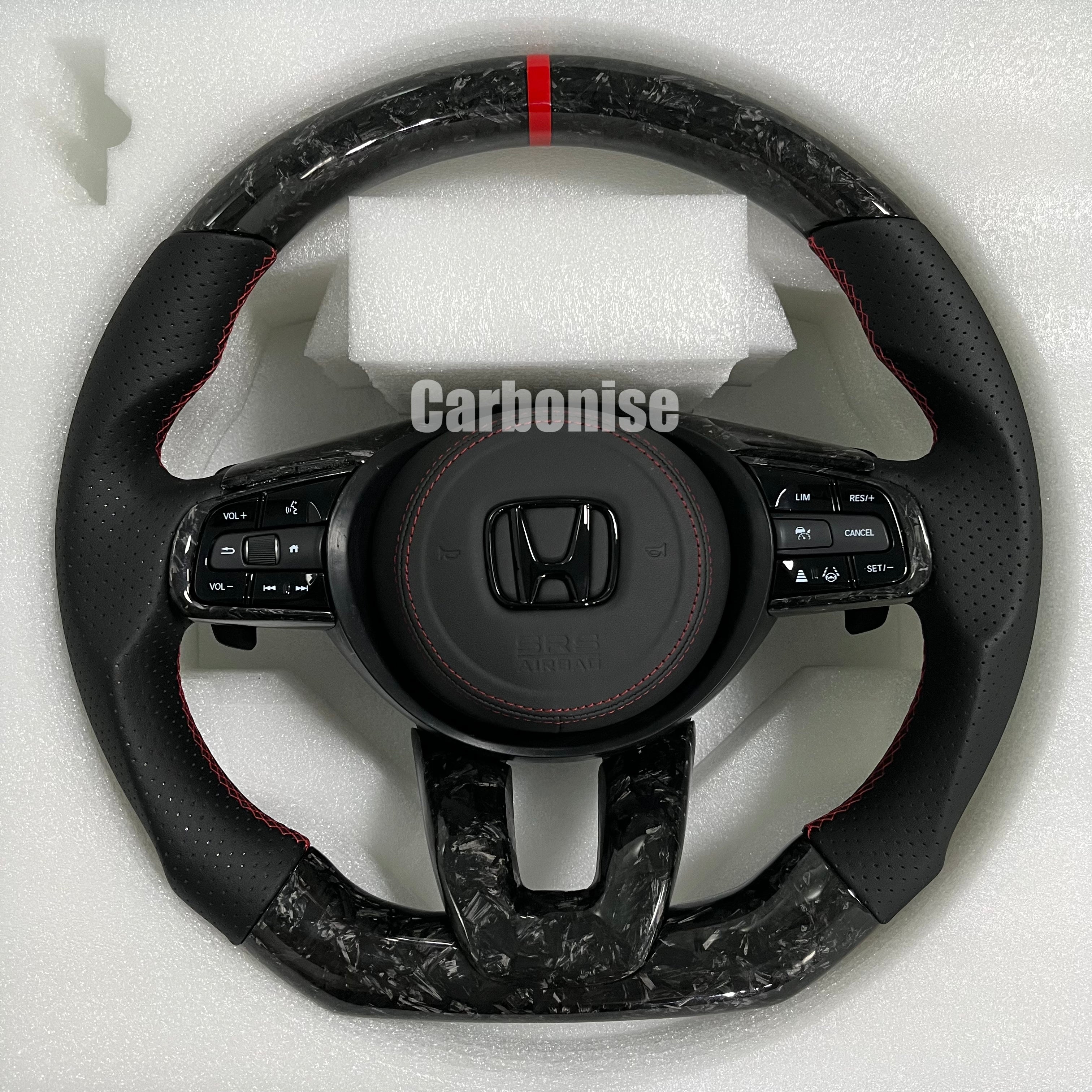 Custom Honda forged carbon steering wheel featuring a red center stripe, black perforated leather side grips, red stitching, and OEM Honda multifunction controls.