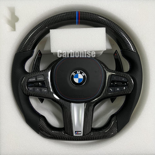 Custom BMW M steering wheel featuring high-gloss carbon fiber, a signature M-tri color top racing stripe, and black perforated leather side grips.