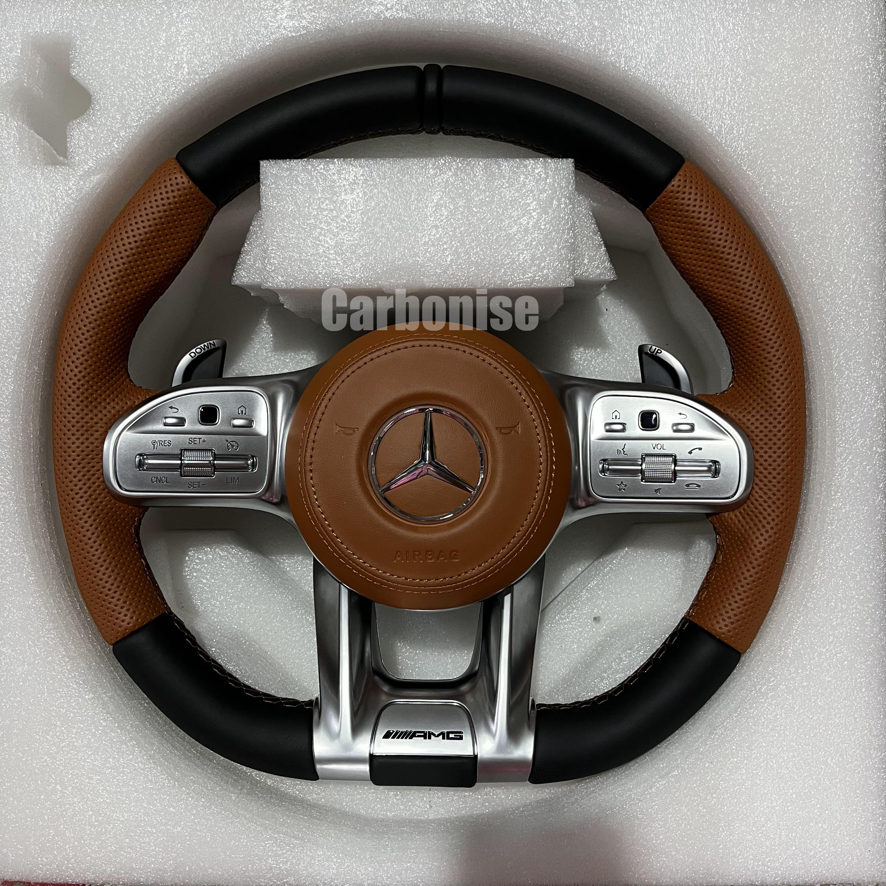 Custom Mercedes-Benz AMG steering wheel featuring a brown leather airbag cover and center, black perforated leather grips, and silver roller controls.