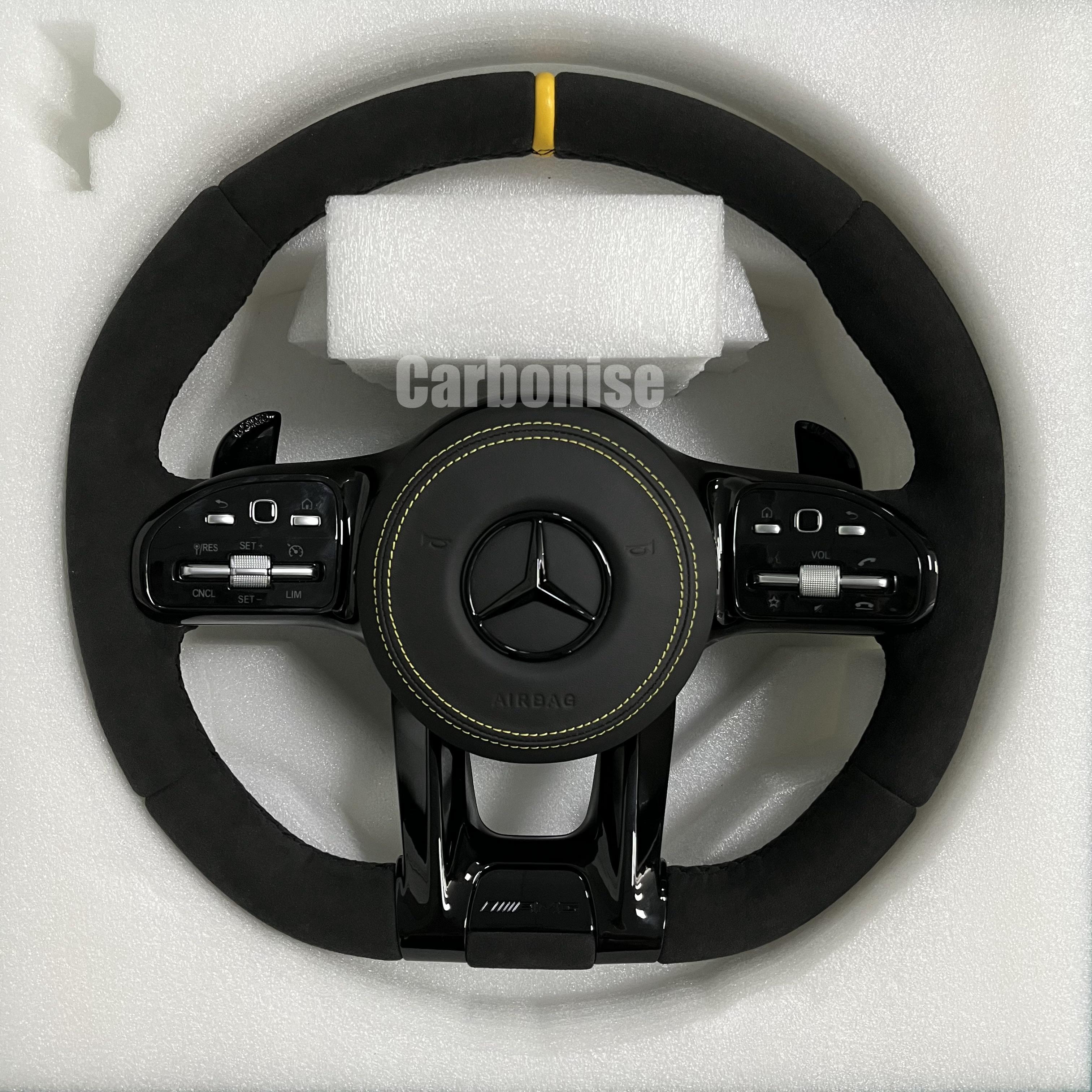 Custom Mercedes-Benz AMG performance steering wheel featuring a full black Alcantara wrap, a yellow top racing stripe, and matching yellow stitching on the airbag cover.