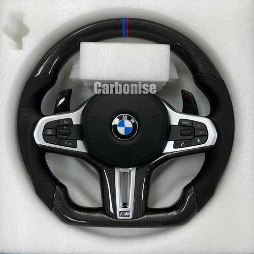 Custom BMW M steering wheel featuring high-gloss carbon fiber, a signature M-tri color top racing stripe, and black perforated leather side grips.