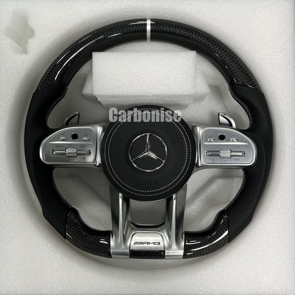 Custom Mercedes-Benz AMG steering wheel featuring high-gloss carbon fiber, a silver top racing stripe, and black perforated leather side grips.