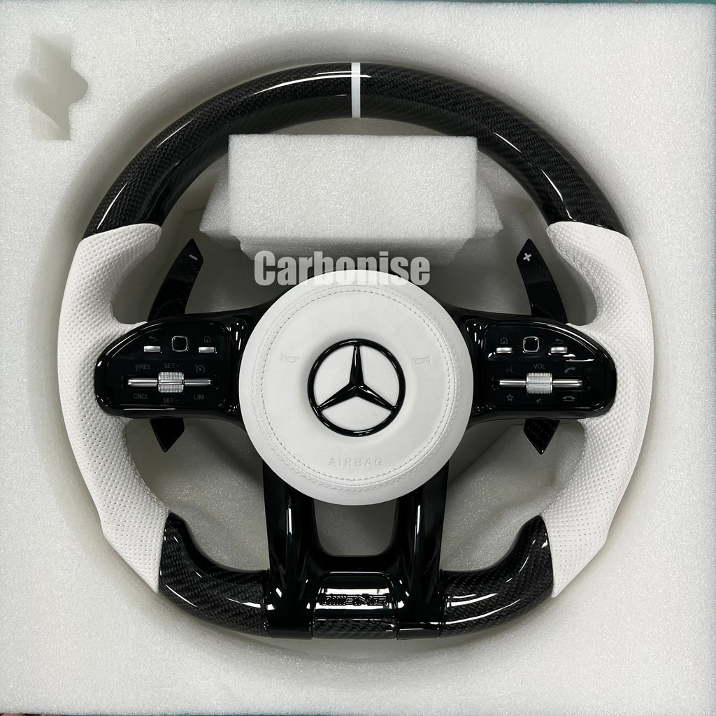Custom Mercedes-Benz AMG steering wheel featuring gloss carbon fiber, white perforated leather grips, and a clean silver top racing stripe.