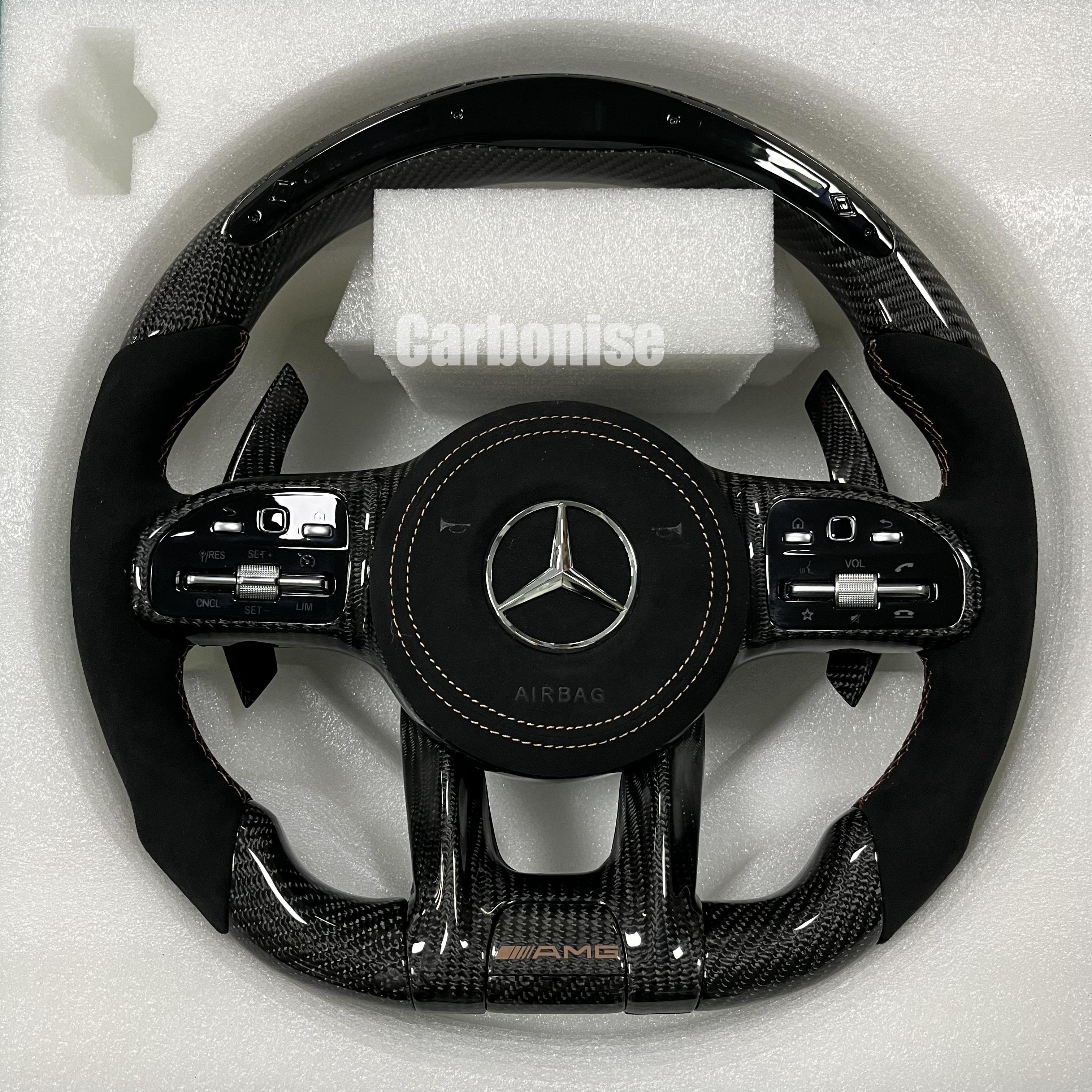 Custom Mercedes-Benz AMG steering wheel featuring high-gloss carbon fiber, a black Alcantara airbag cover, and matching black Alcantara side grips.