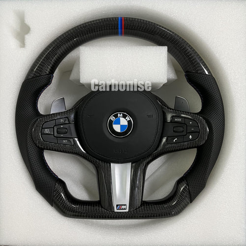 Custom BMW M performance steering wheel featuring high-gloss carbon fiber, a signature M-tri color top racing stripe, and black perforated leather grips.