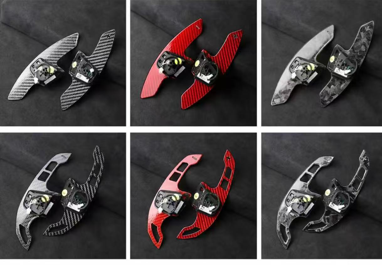 Extended carbon fibre paddle shifters in multiple finishes including gloss carbon, forged carbon, red forged carbon, and grey forged carbon.