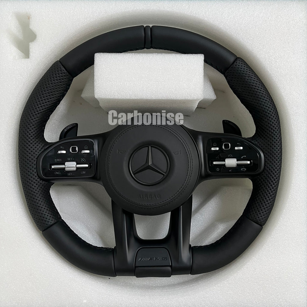 Custom Mercedes-Benz AMG steering wheel featuring a full matte black finish, black perforated leather side grips, and integrated silver roller controls.