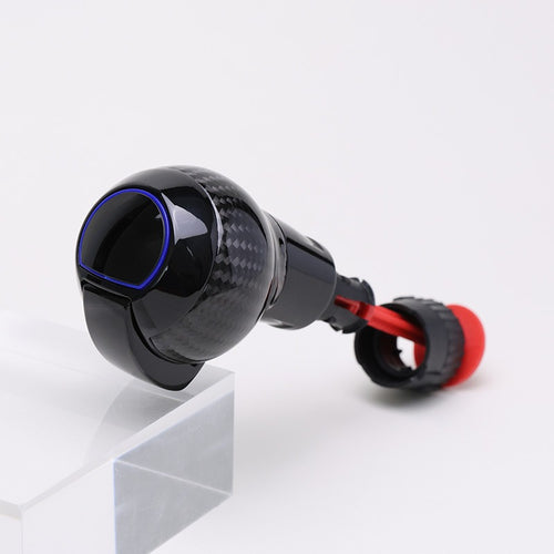 Carbon fibre gear shift knob with gloss black finish, red accent ring, and rounded performance design.
