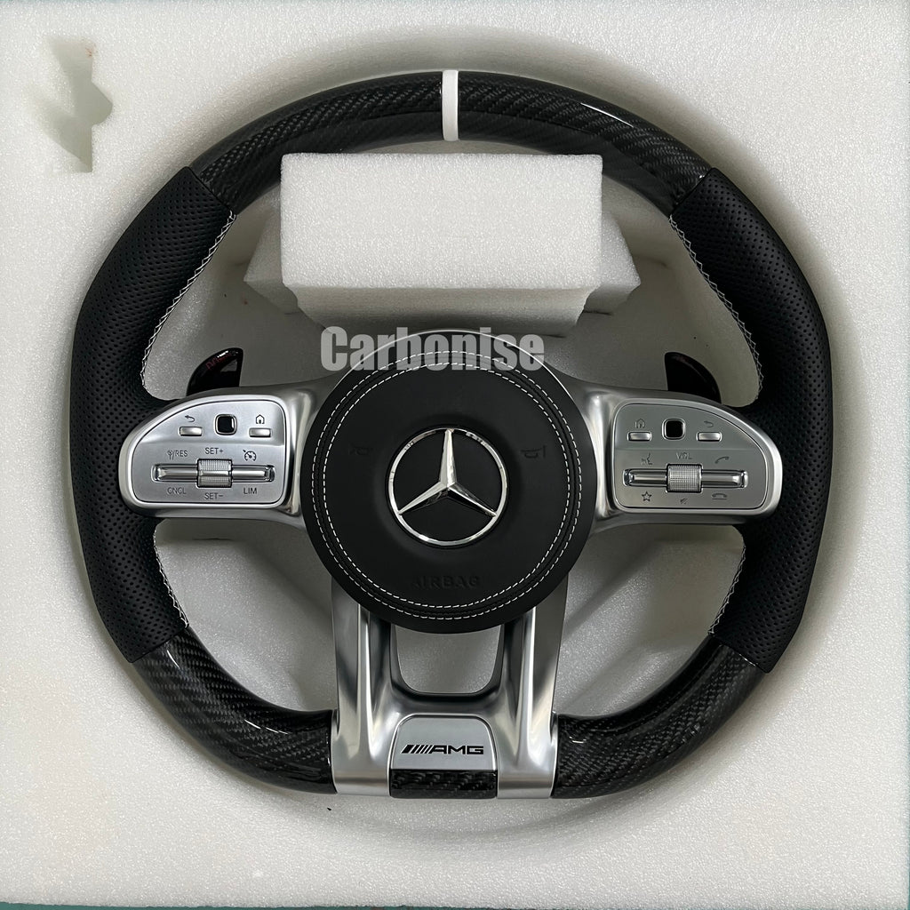 Custom Mercedes-Benz AMG steering wheel featuring gloss carbon fiber, black perforated leather side grips with white stitching, and a clean silver top racing stripe.
