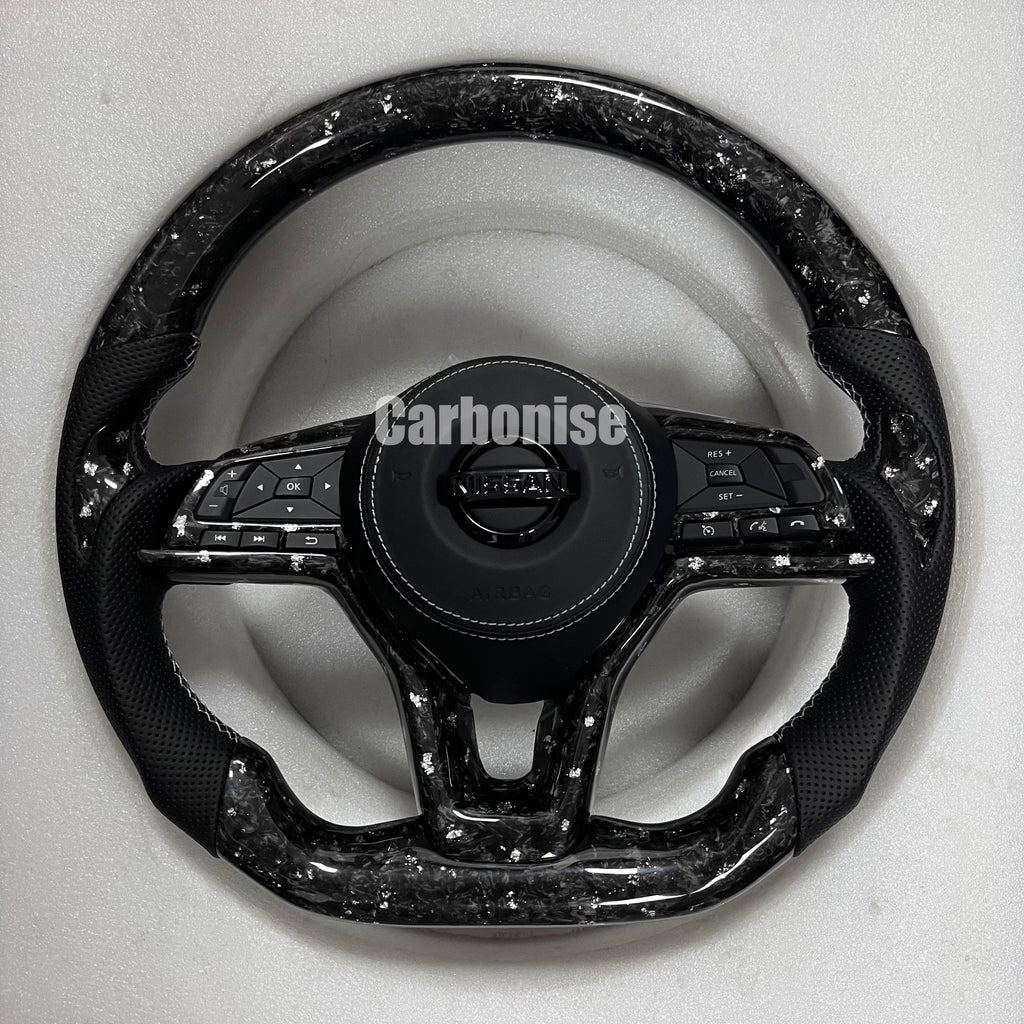 Carbonise Nissan forged carbon steering wheel with perforated leather grips and flat bottom design