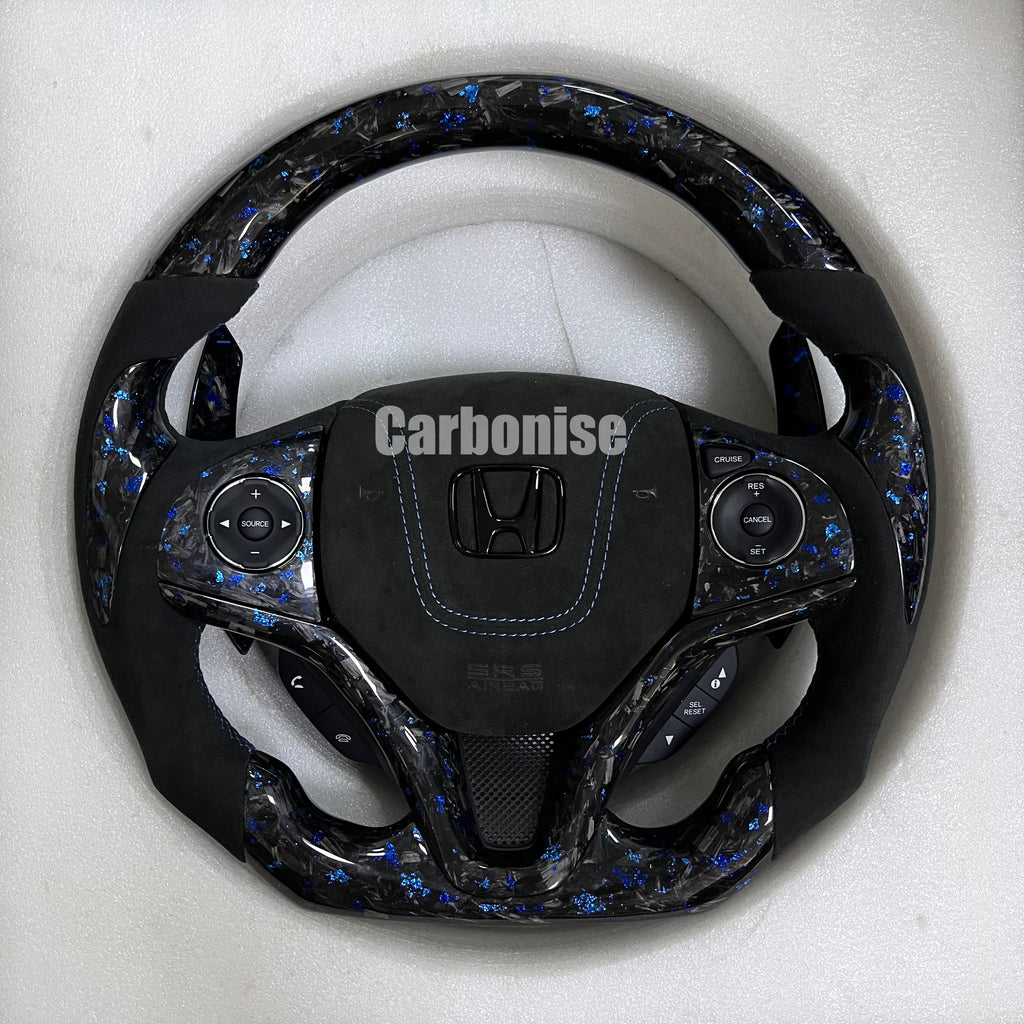 Custom Honda forged carbon steering wheel with blue flake carbon finish, black Alcantara grips, blue stitching, and flat bottom performance design.