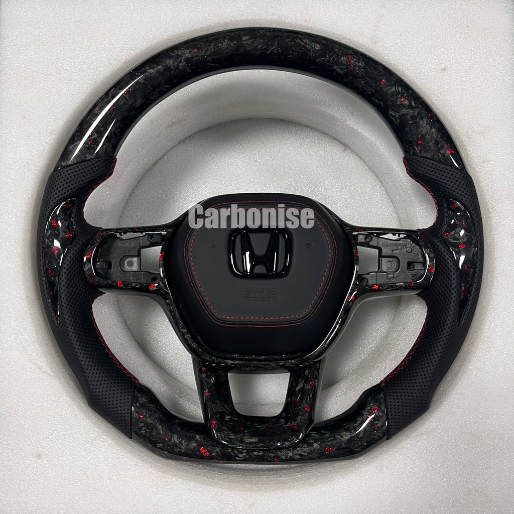 Custom Honda forged carbon steering wheel with red flake carbon finish, black perforated leather side grips, red stitching, and flat bottom design.