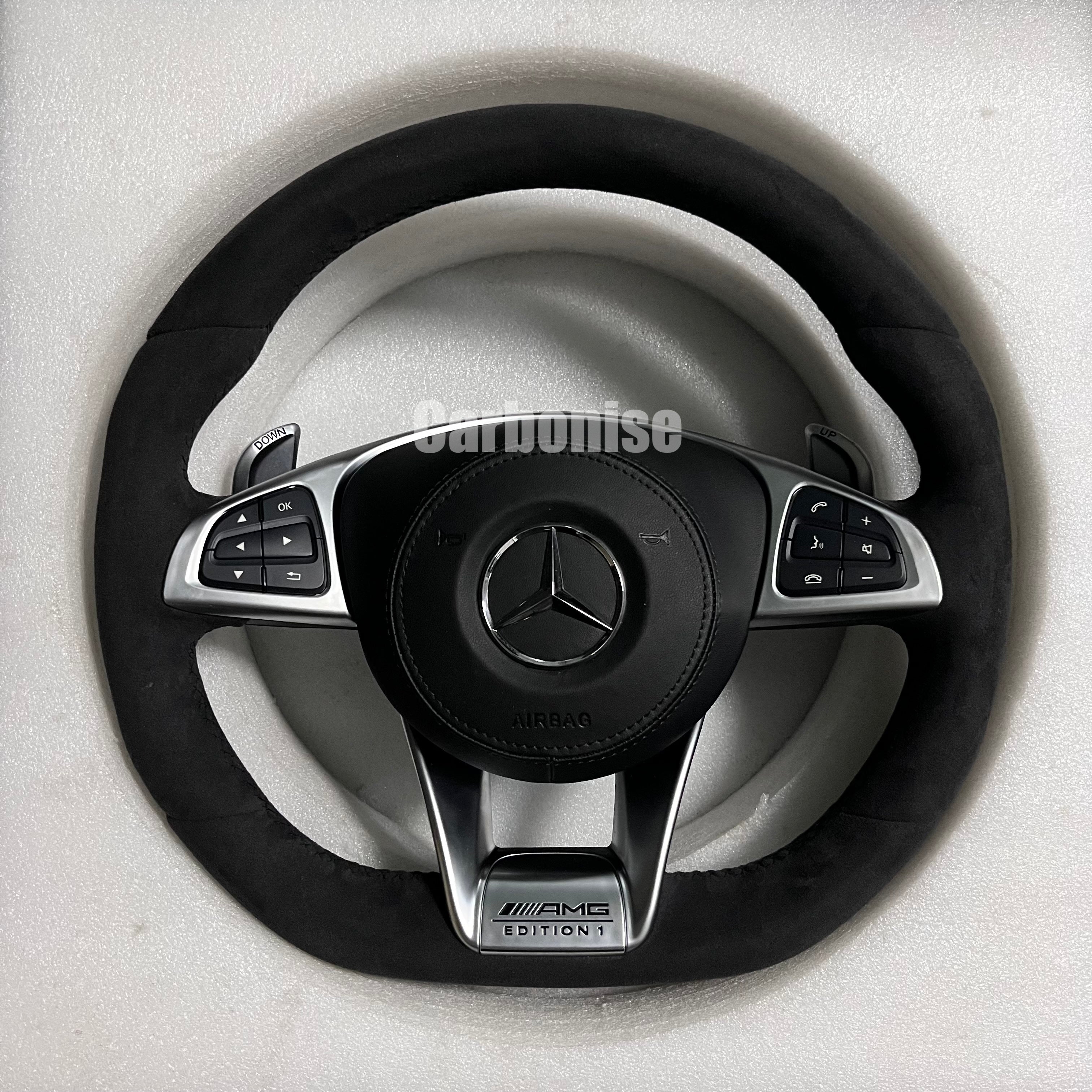 Custom Mercedes-Benz AMG performance steering wheel featuring a full black Alcantara wrap, silver Edition 1 lower trim, and integrated silver paddle shifters.