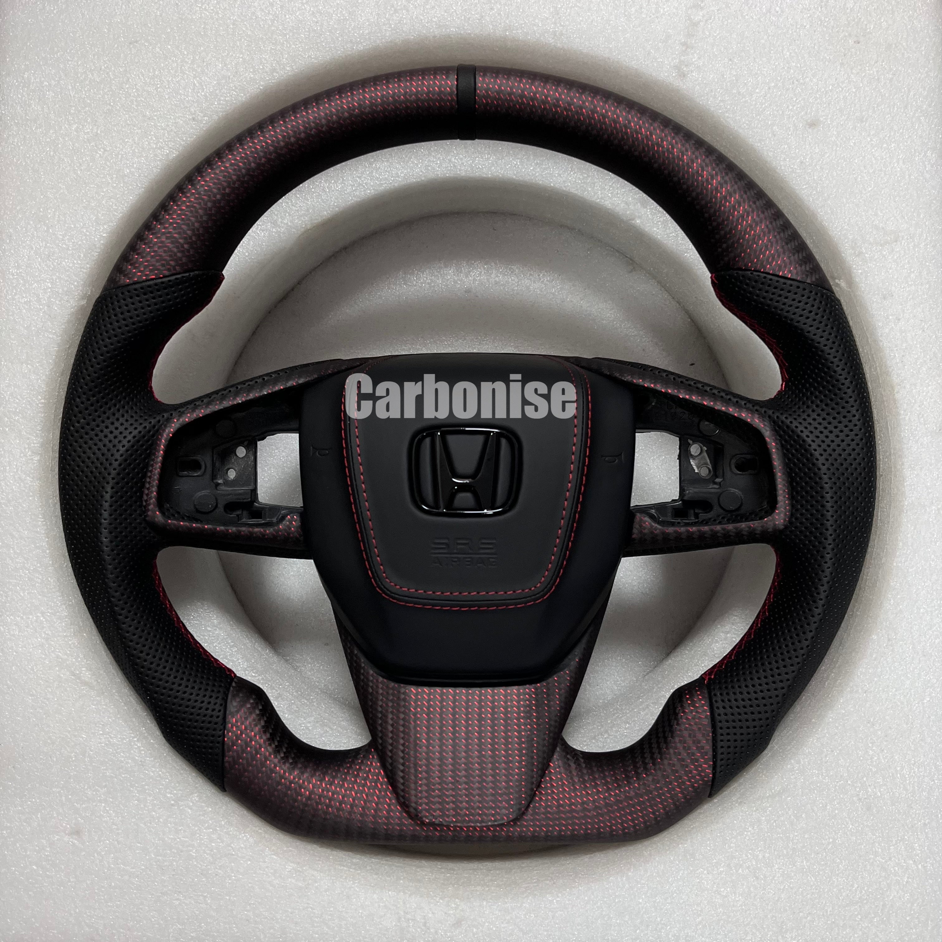 Custom Honda steering wheel with red forged carbon finish, perforated black side grips, red stitching, and OEM airbag compatibility.