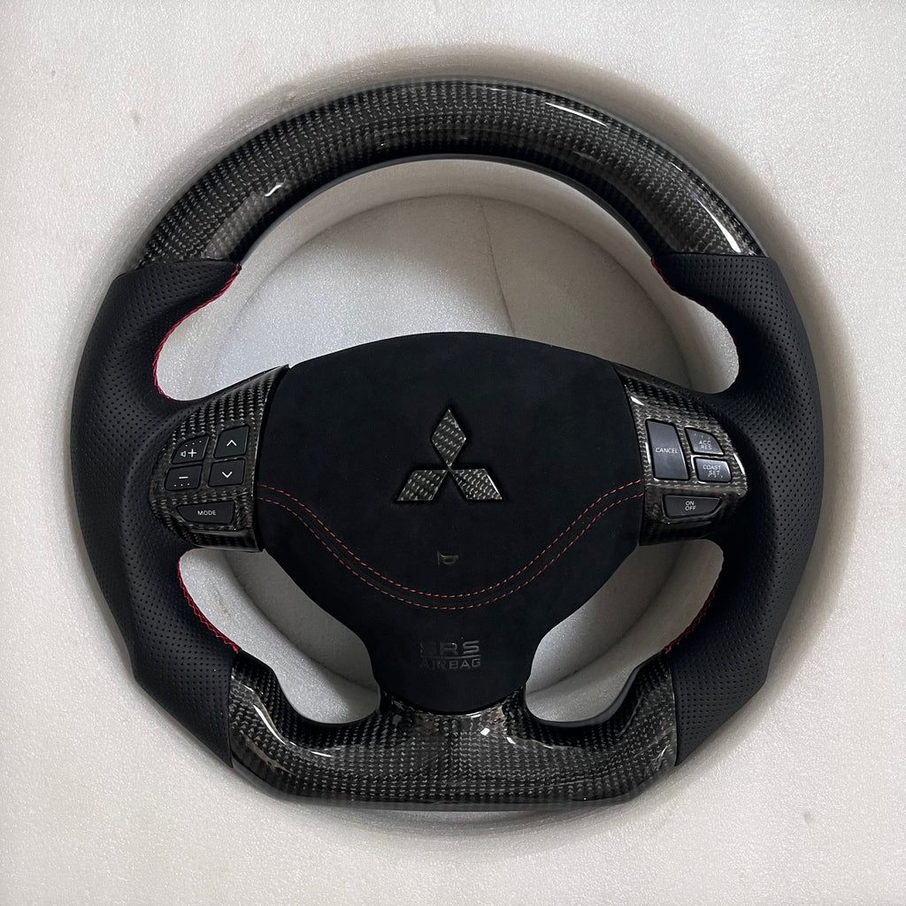 Carbonise Mitsubishi carbon fiber steering wheel with alcantara center and perforated leather grips