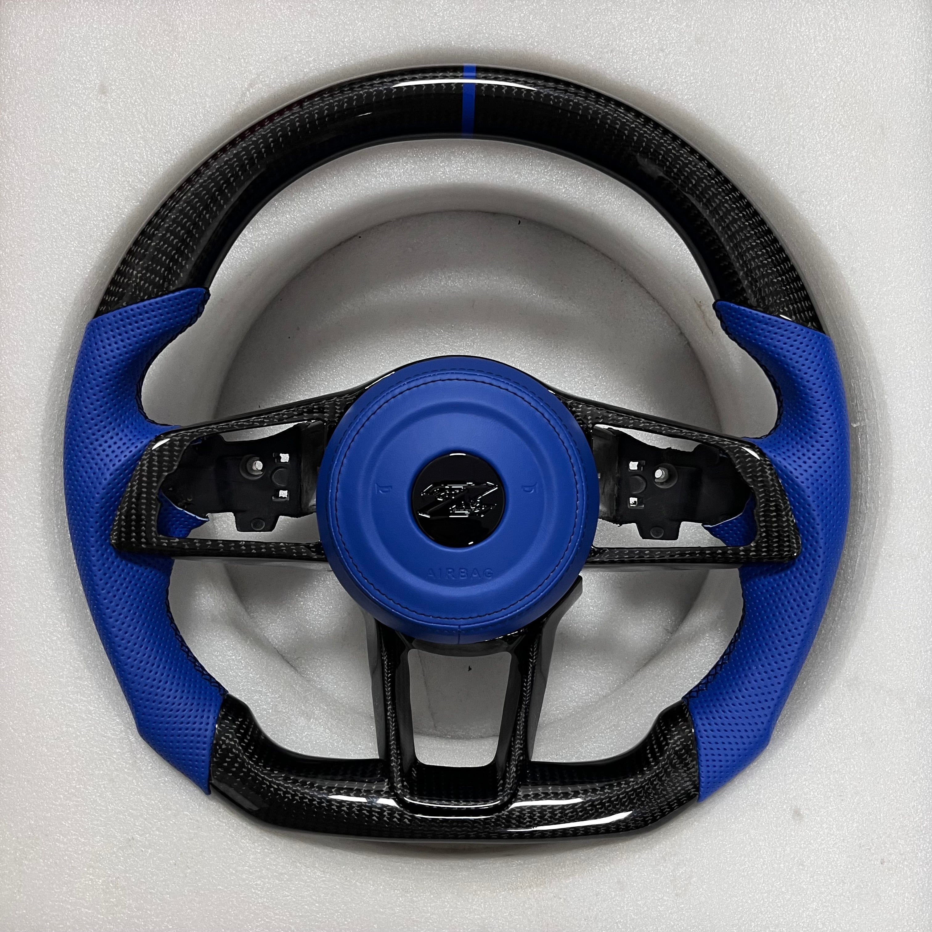 Carbonise Nissan Z carbon fiber steering wheel with blue perforated leather grips and flat bottom design