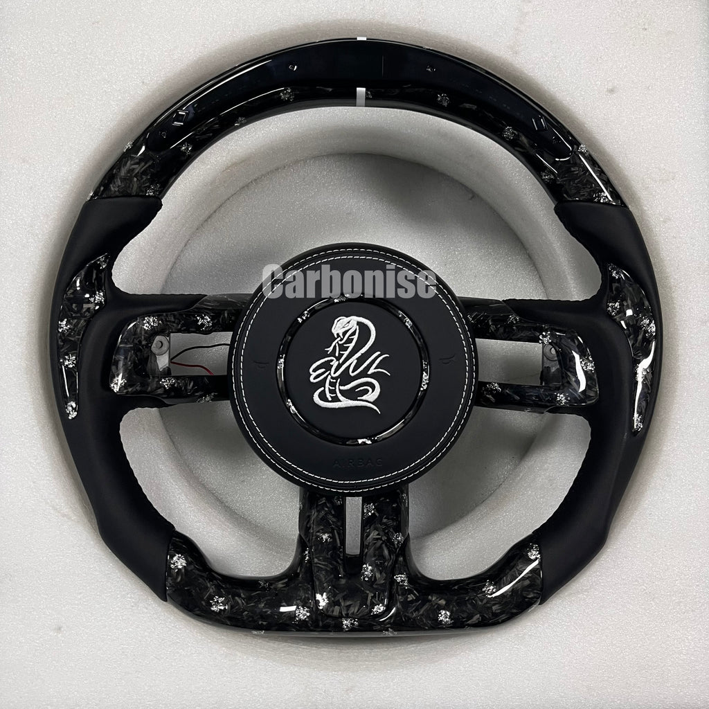 Custom forged carbon fibre steering wheel with white flakes, Alcantara side grips, white centre stripe, white stitching, matching forged carbon spokes, and custom logo airbag.