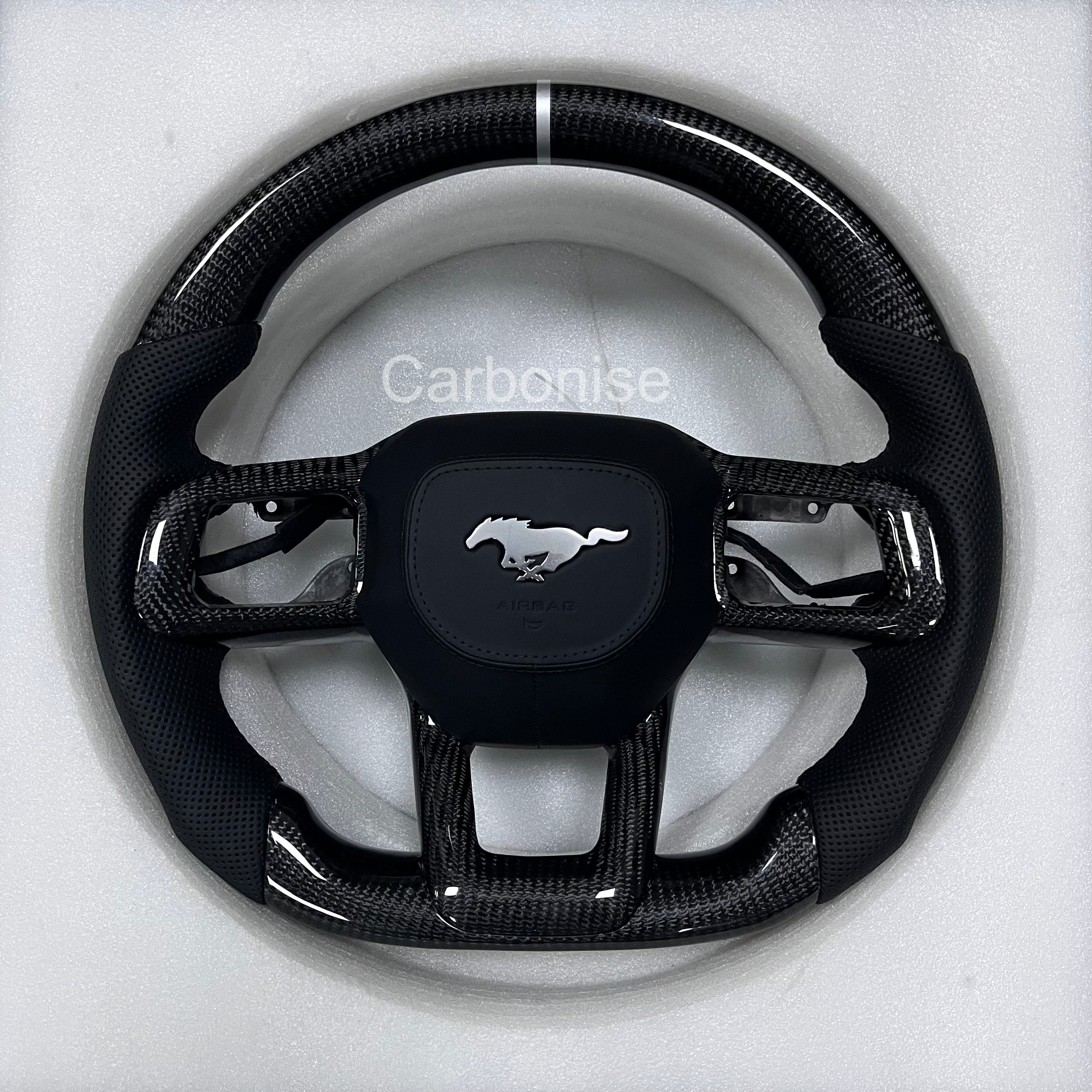Ford Mustang carbon fibre steering wheel with perforated black leather grips, white centre stripe, round design, and OEM Mustang airbag.