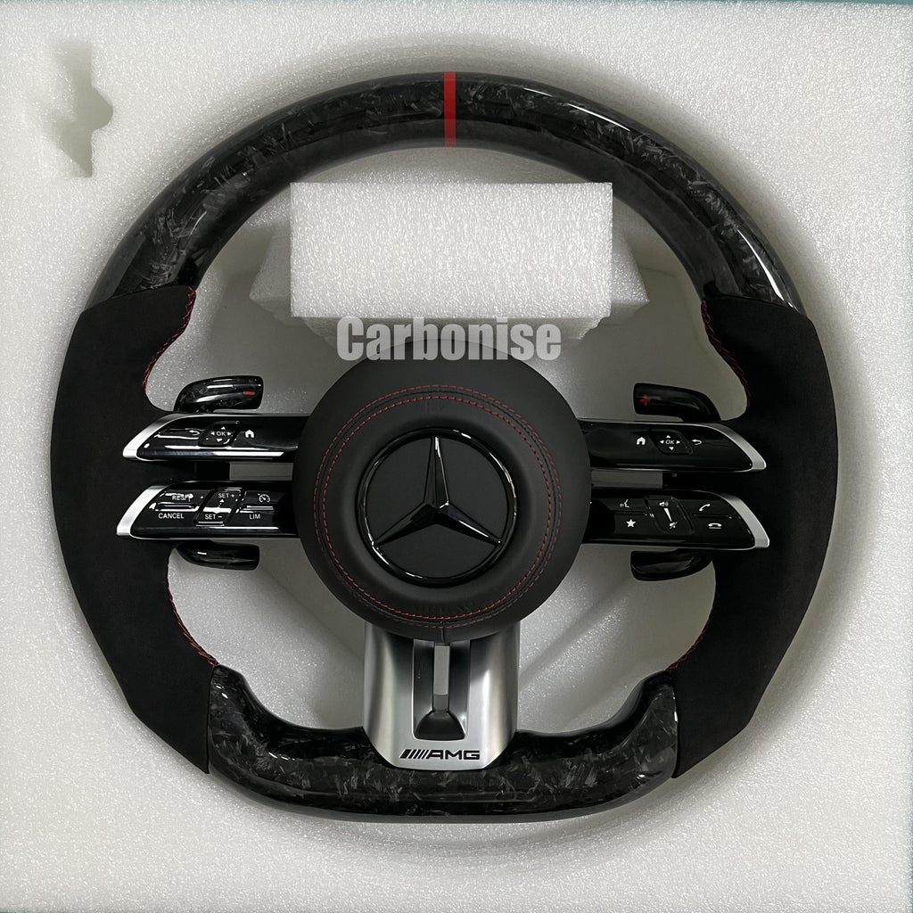 Custom Mercedes-Benz AMG steering wheel featuring high-gloss marbled forged carbon fiber, a red top racing stripe, and black Alcantara side grips with red stitching.