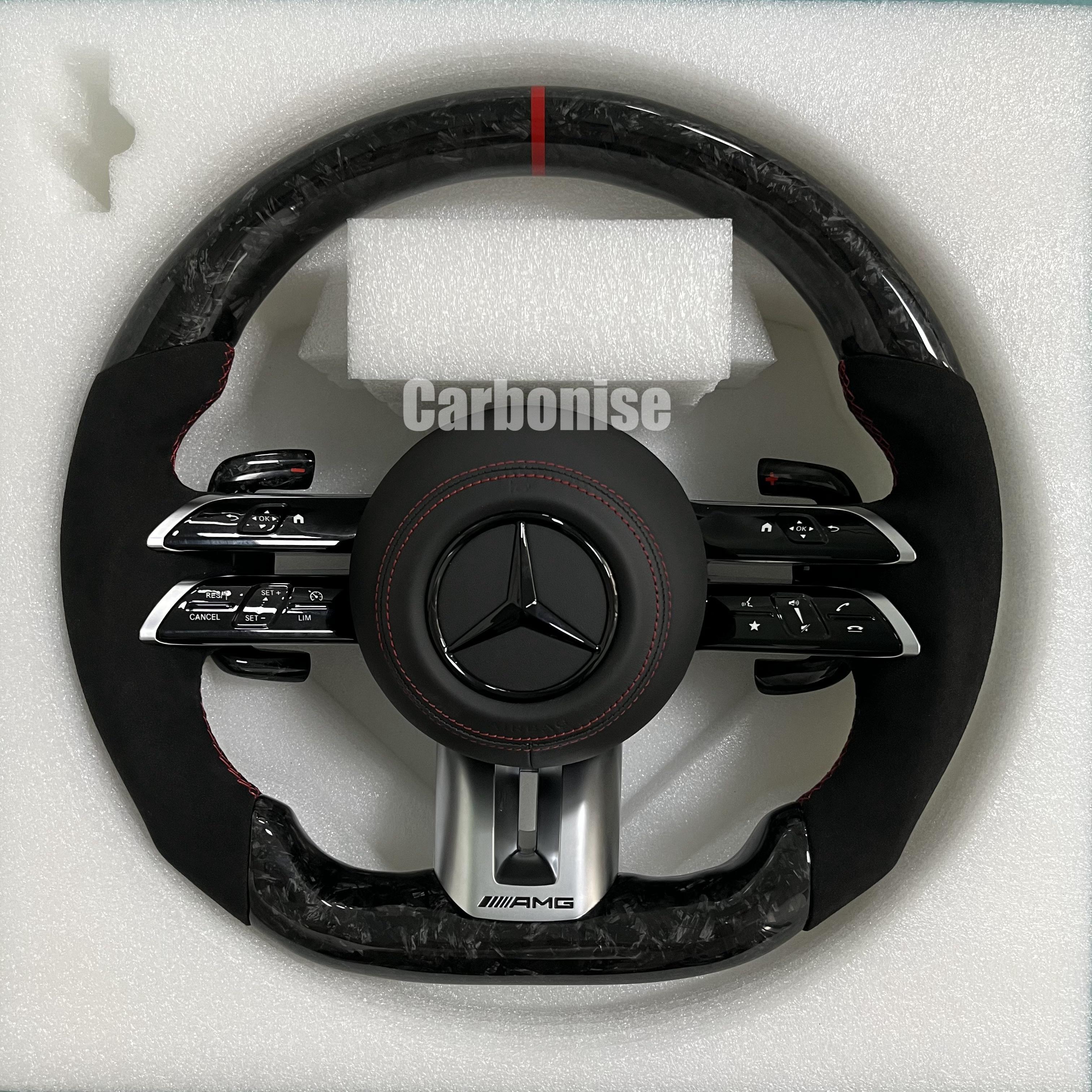 Custom Mercedes-Benz AMG steering wheel featuring high-gloss marbled forged carbon fiber, a red top racing stripe, and black Alcantara side grips with red stitching.