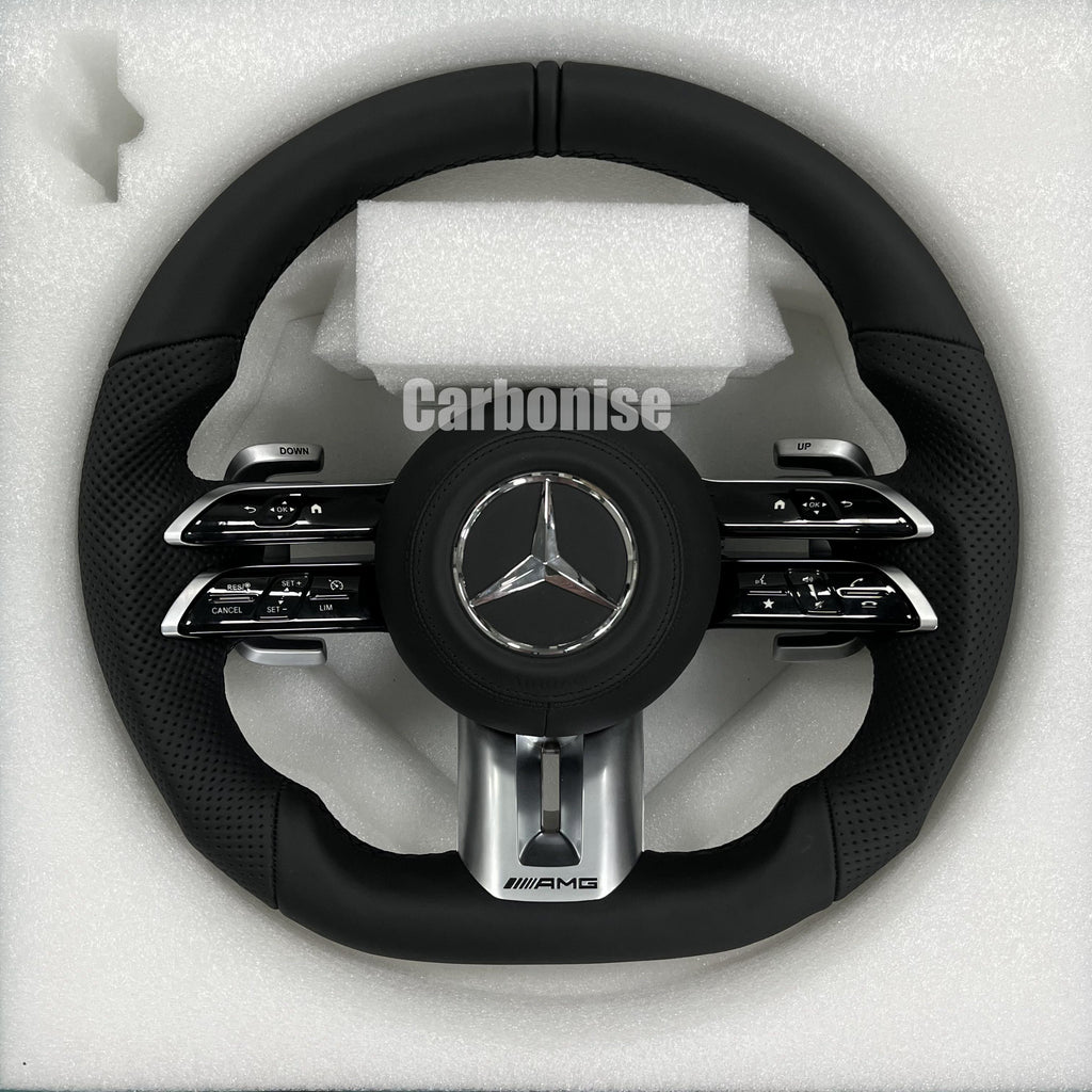Custom Mercedes-Benz AMG steering wheel featuring a full black leather wrap with perforated side grips and integrated silver performance hardware.