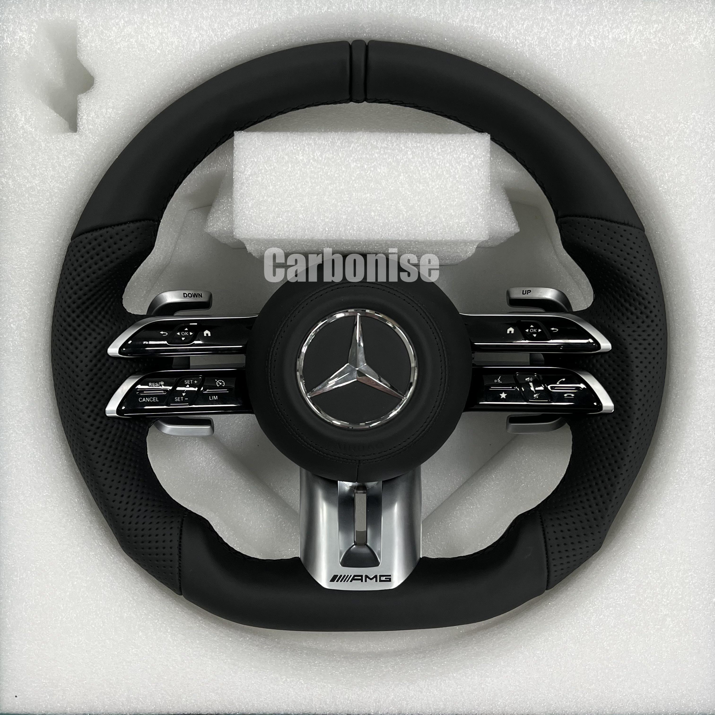 Custom Mercedes-Benz AMG steering wheel featuring a full black leather wrap with perforated side grips and integrated silver performance hardware.