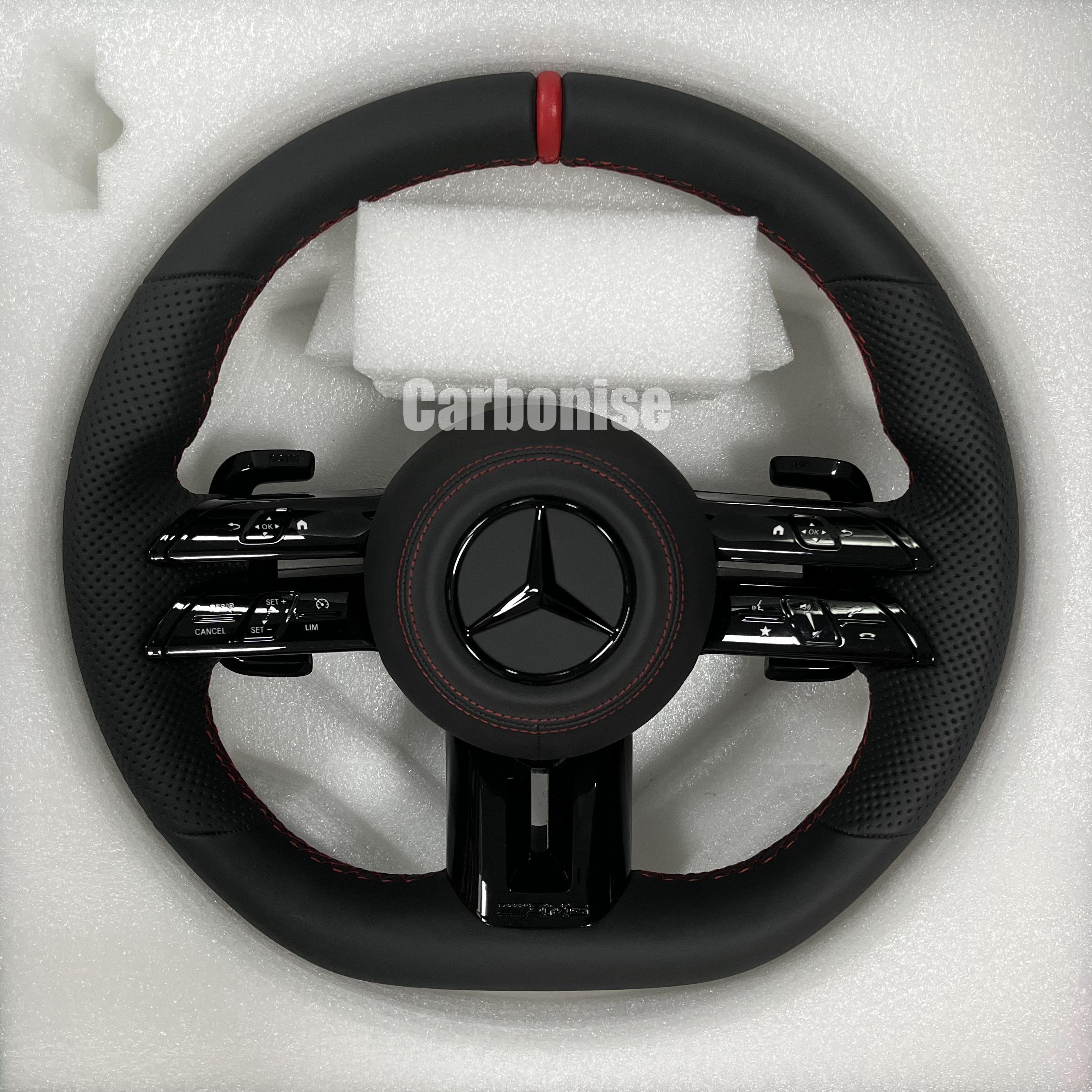 Custom Mercedes-Benz AMG steering wheel featuring a full black leather wrap, a red top racing stripe, and perforated side grips with red stitching.