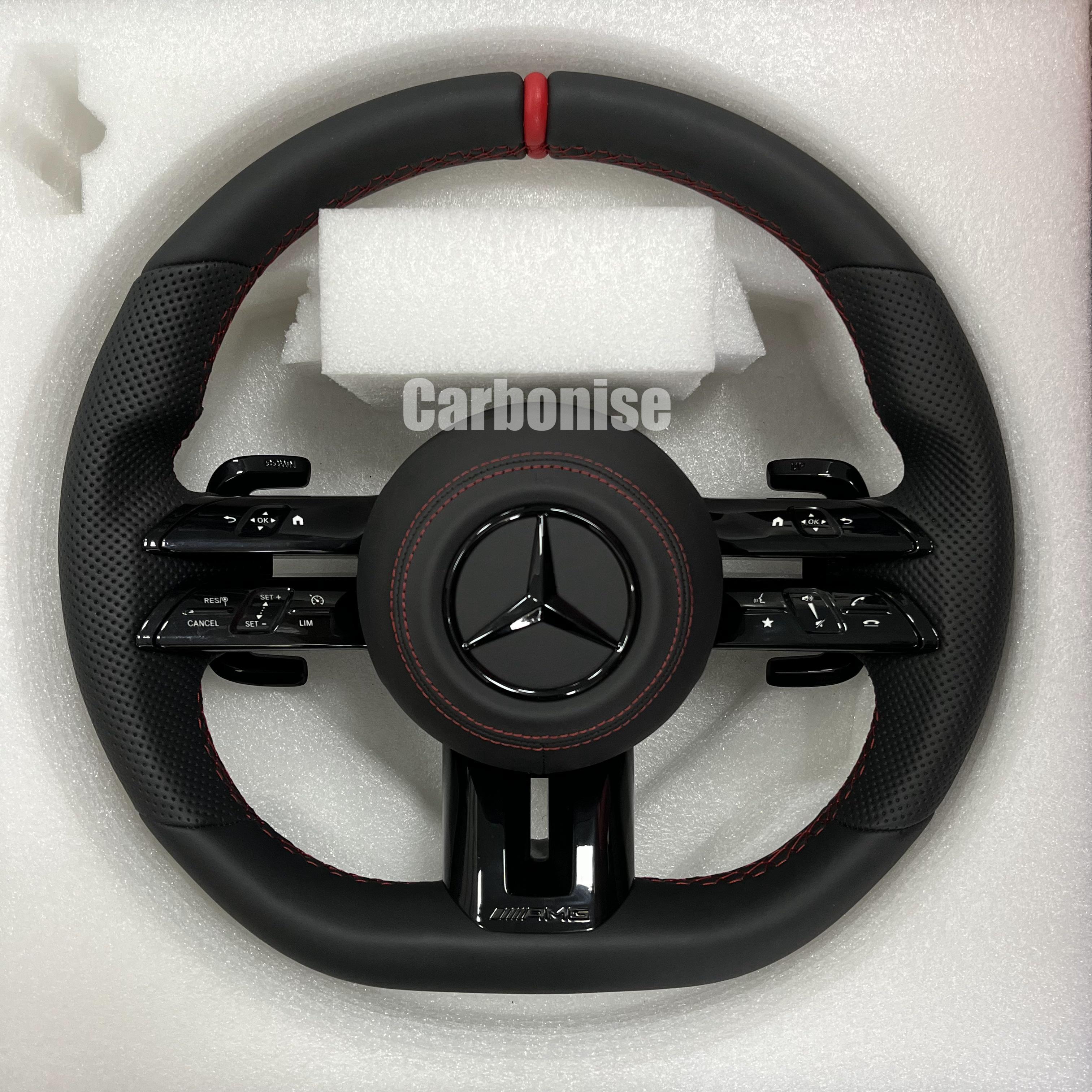 Custom Mercedes-Benz AMG steering wheel featuring a full black leather wrap, a red top racing stripe, and black perforated leather side grips with red stitching.