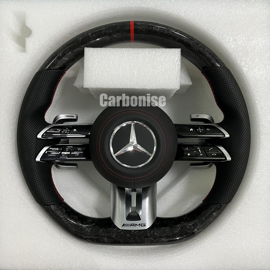 Custom Mercedes-Benz AMG steering wheel featuring high-gloss marbled forged carbon fiber, a red top racing stripe, and black perforated leather side grips with red stitching.