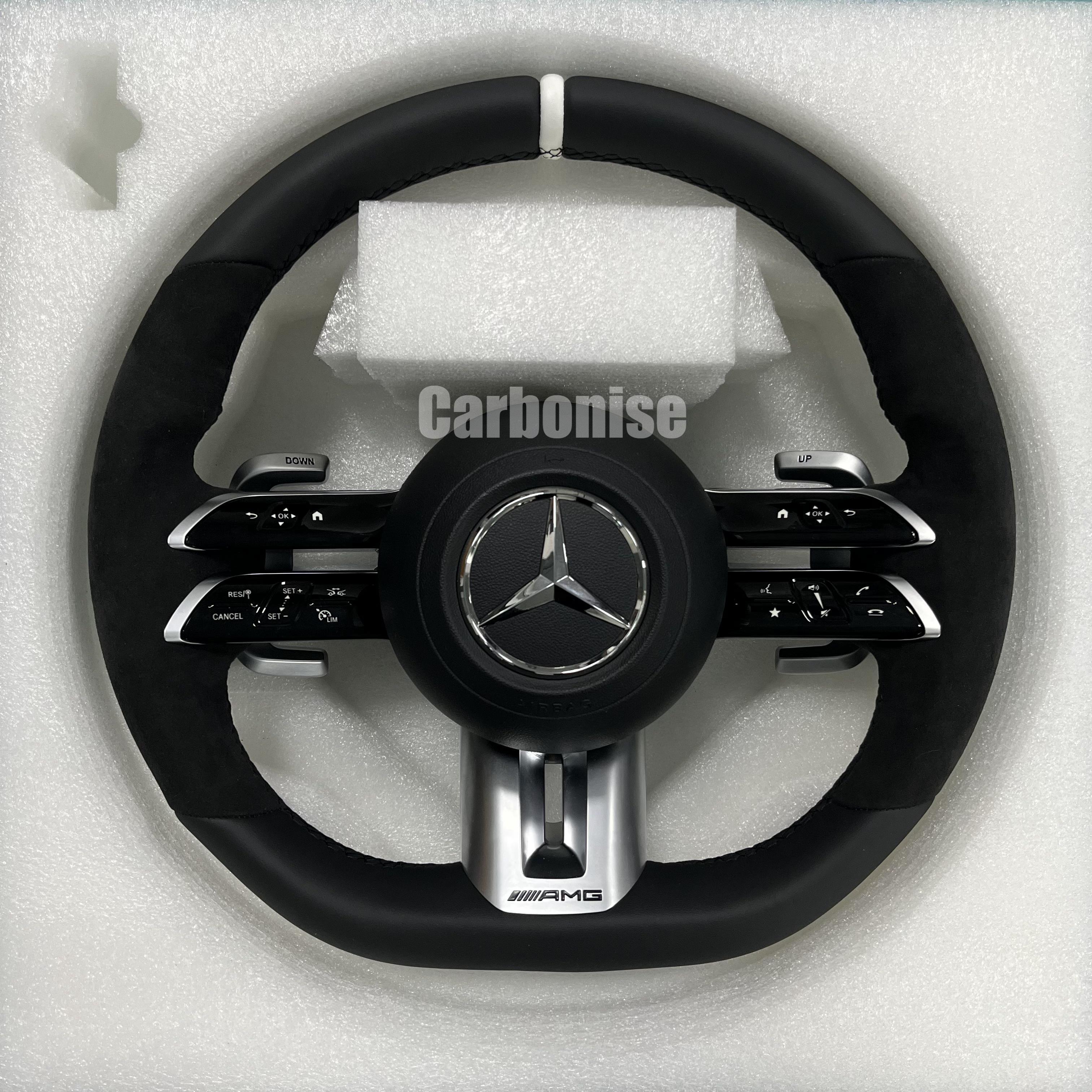 Custom Mercedes-Benz AMG steering wheel featuring a full black leather and Alcantara wrap with a white top racing stripe and silver hardware.