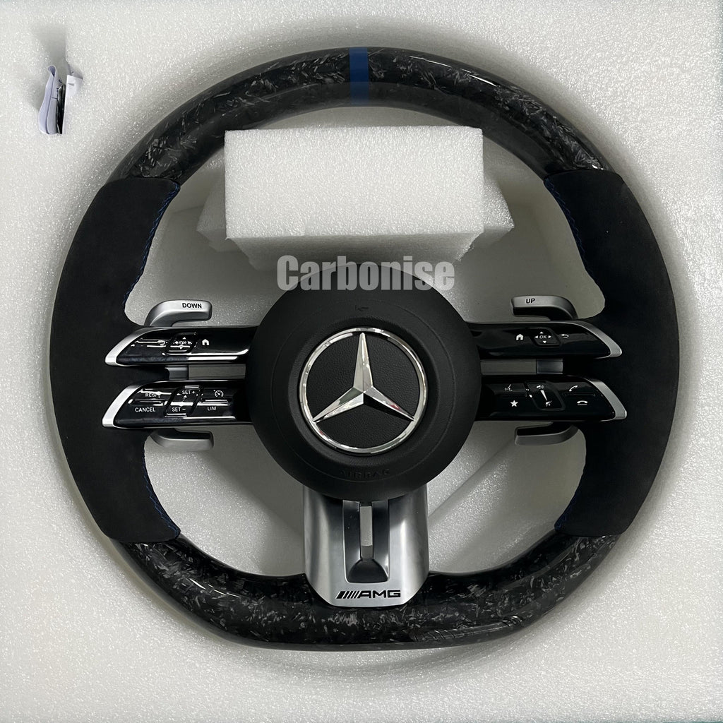 Custom Mercedes-Benz AMG steering wheel featuring high-gloss marbled forged carbon fiber, a blue top racing stripe, and black Alcantara side grips.