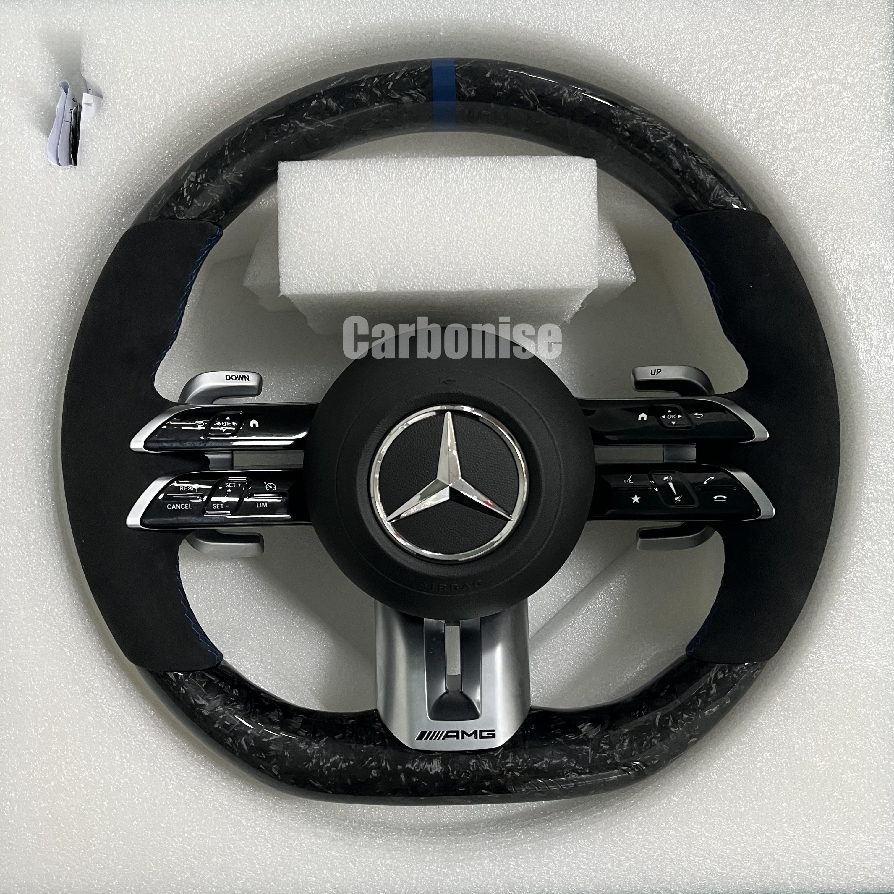 Custom Mercedes-Benz AMG steering wheel featuring high-gloss marbled forged carbon fiber, a blue top racing stripe, and black Alcantara side grips.