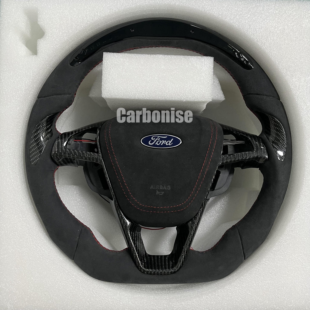 Custom Ford carbon fibre steering wheel with Alcantara grip, red stitching, flat-bottom design, and OEM Ford airbag.
