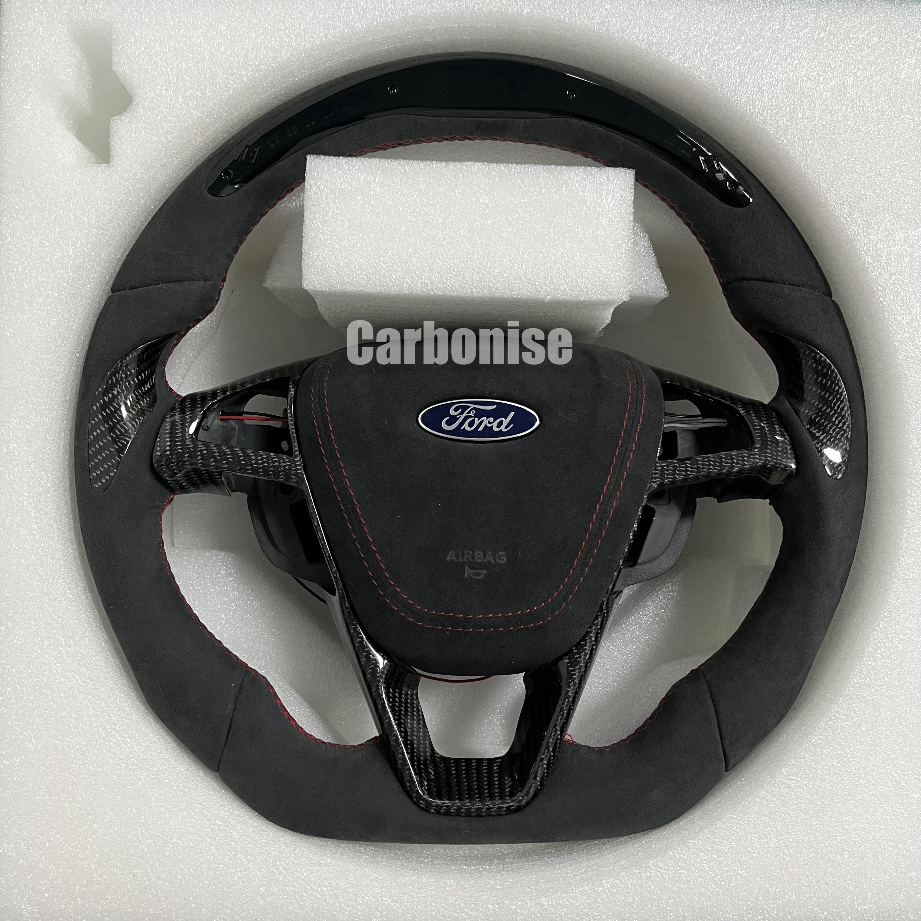 Custom Ford carbon fibre steering wheel with Alcantara grip, red stitching, flat-bottom design, and OEM Ford airbag.
