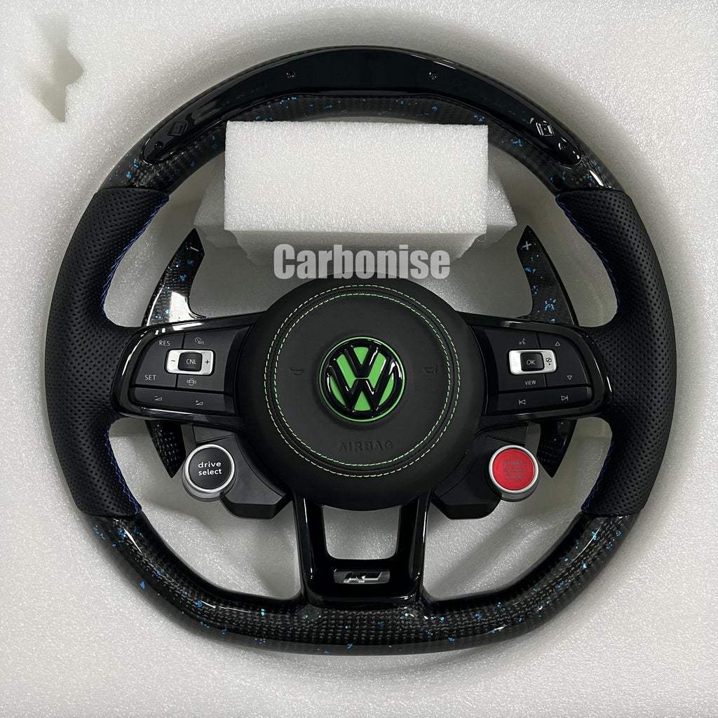 Custom Volkswagen performance steering wheel featuring high-gloss carbon fiber with blue flakes, integrated R8-style red start/stop buttons, and a lime green VW logo.