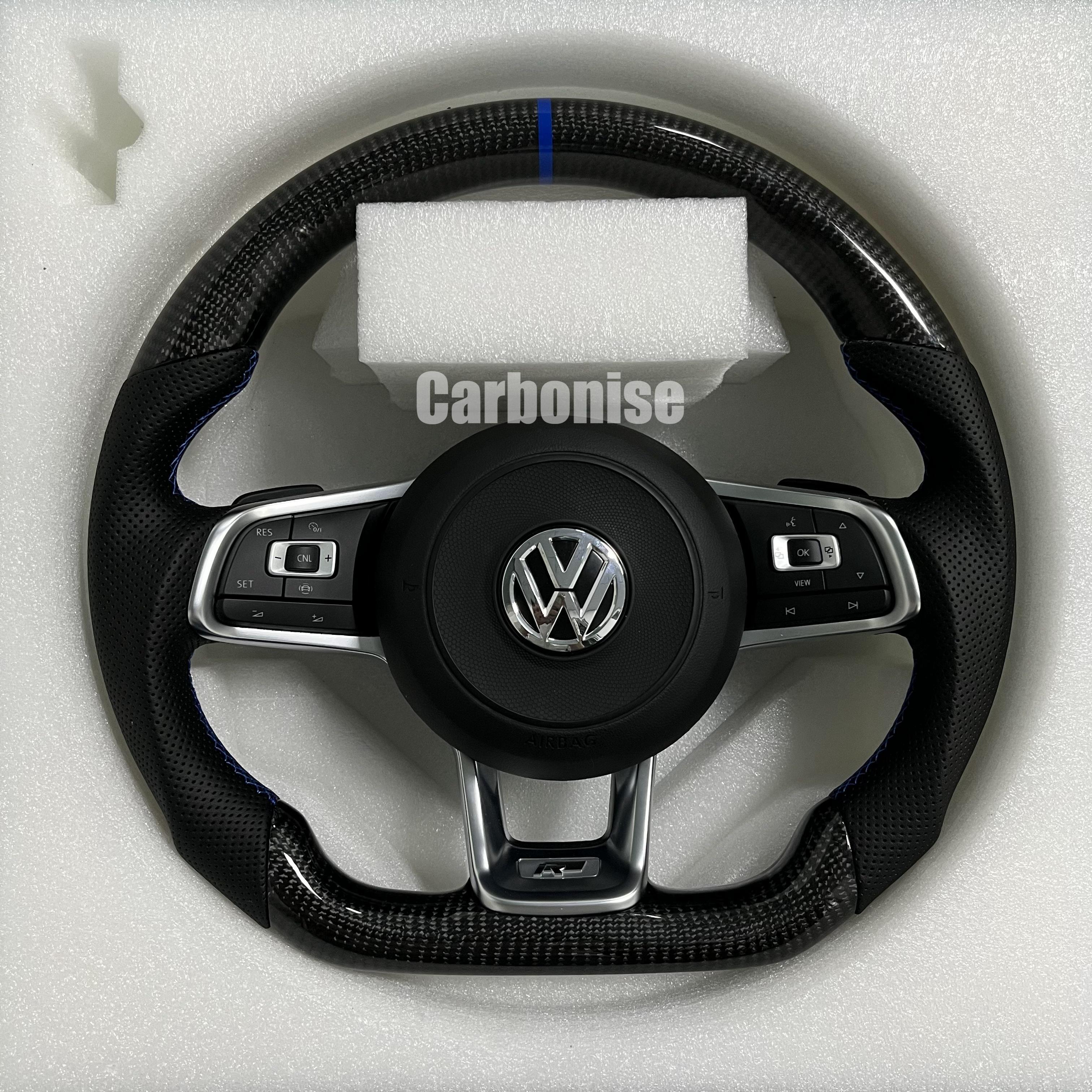 Custom Volkswagen performance steering wheel featuring high-gloss carbon fiber, a blue top racing stripe, and black perforated leather side grips with blue stitching.